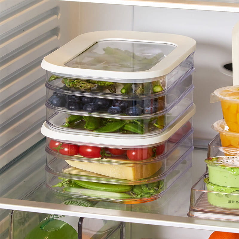 Clear stackable food storage containers organized inside refrigerator